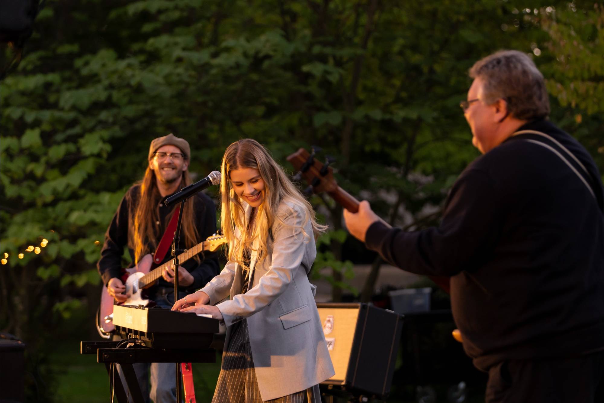 Izzy Joy and band smiling on stage performing